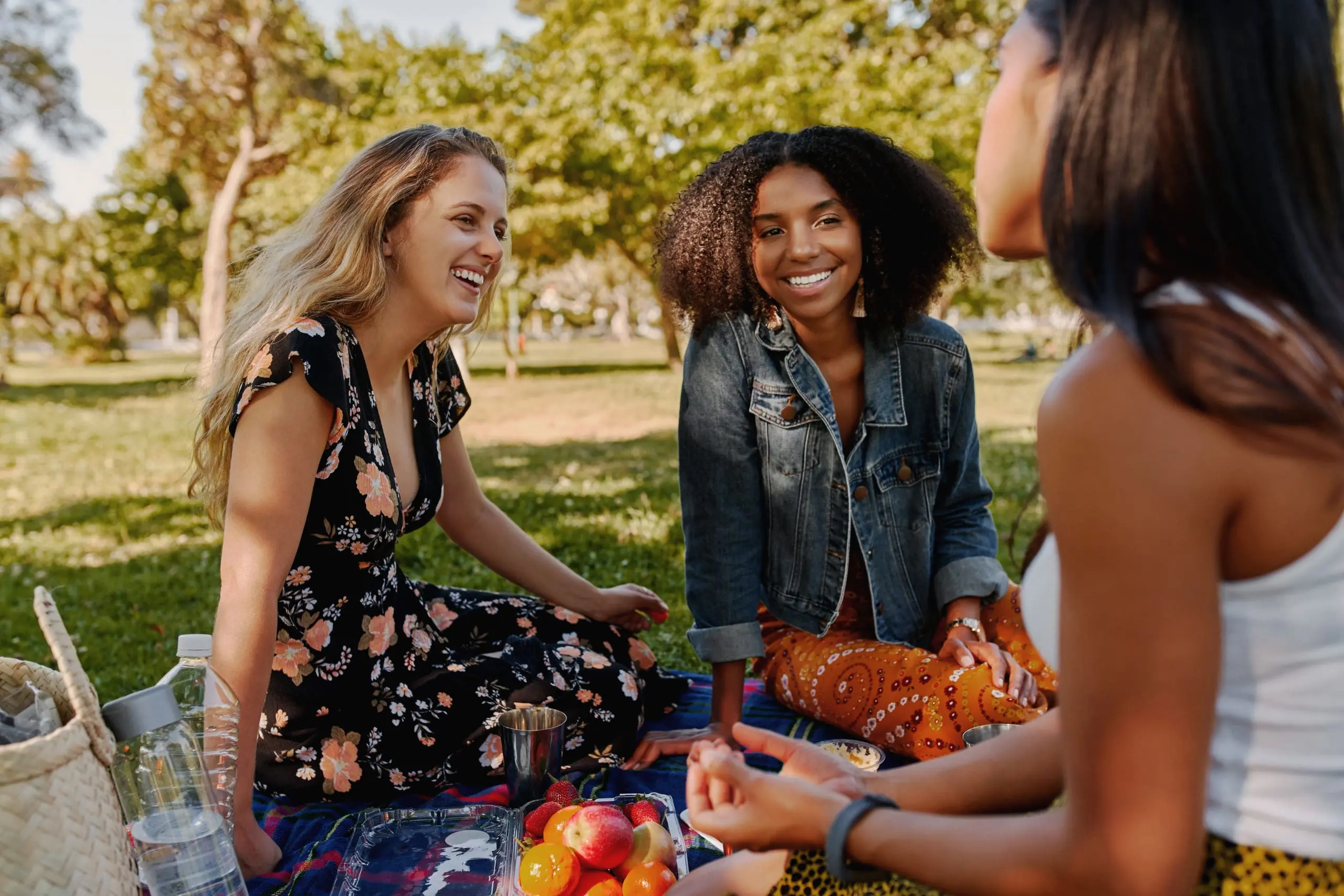 Group Of Smiling Multiracial Female Best Friends Sitting Togethe